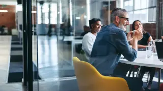 Zespół siedzący w sali konferencyjnej